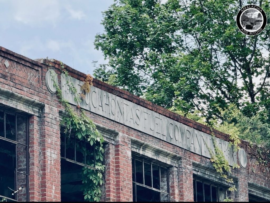 Entablature reading “Pocahontas Fuel Company Inc 1917” on Boissevain company store, vines threading through window frames.
