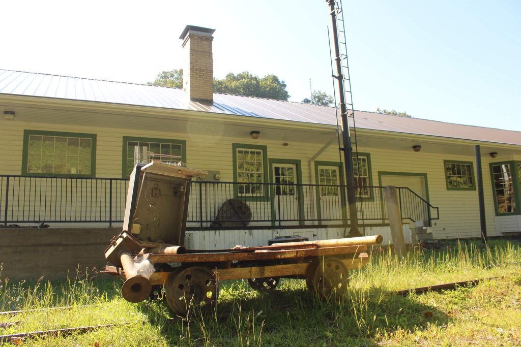 Old railroad cart and trackside equipment on display outside the Jenkins Depot (David A. Zegeer Coal-Railroad Museum) in Jenkins, Kentucky.